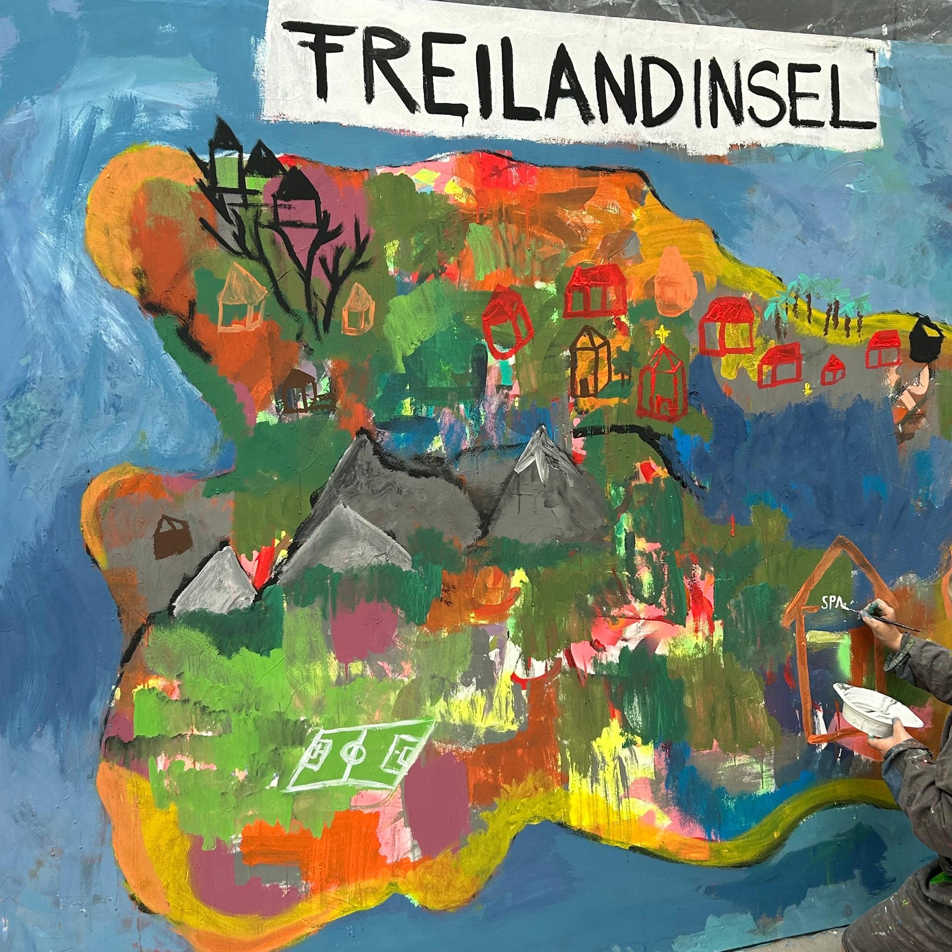 Foto einer Leinwand, darauf ist eine gemalte Insel.