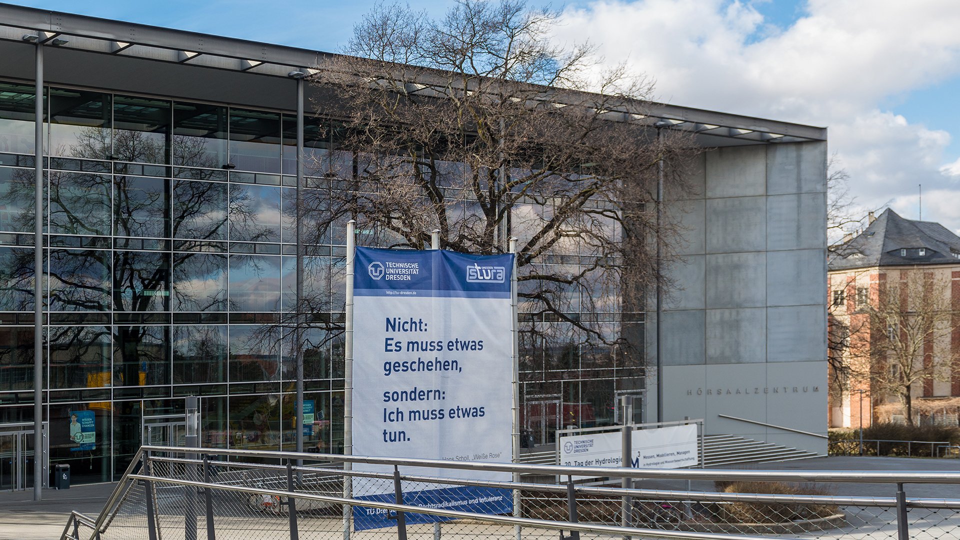 Banner vor der TU Dresden mit der Aufschrift "Nicht: Es muss etwas geschehen, sondern: Ich muss etwas tun".