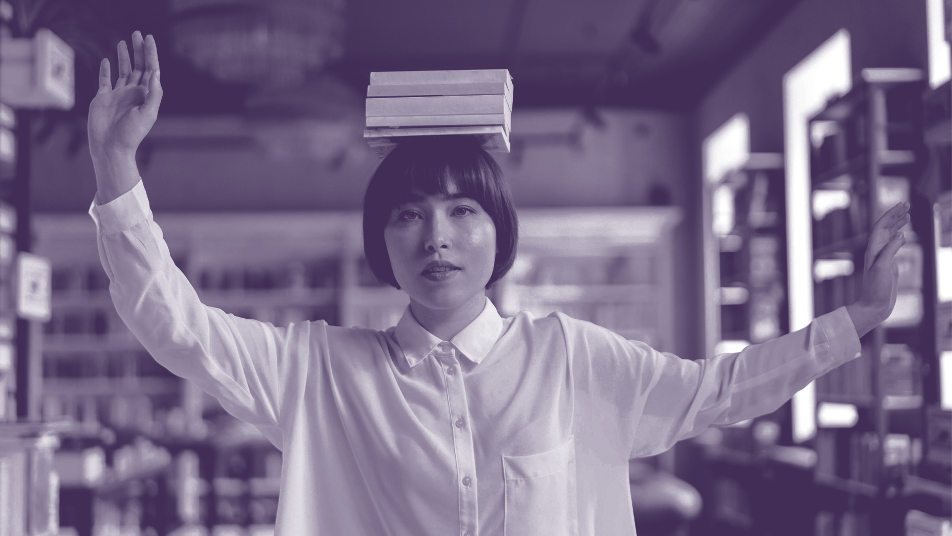 Foto einer Frau, die Bücher auf ihrem Kopf balanciert.