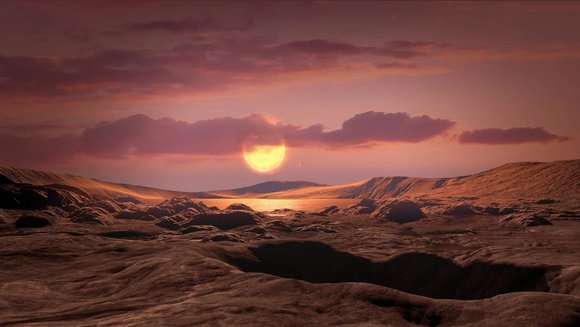Künstlerische Darstellung eines felsigen Exoplaneten mit Erdmasse wie Wolf 1069 b, der einen roten Zwergstern umkreist. 