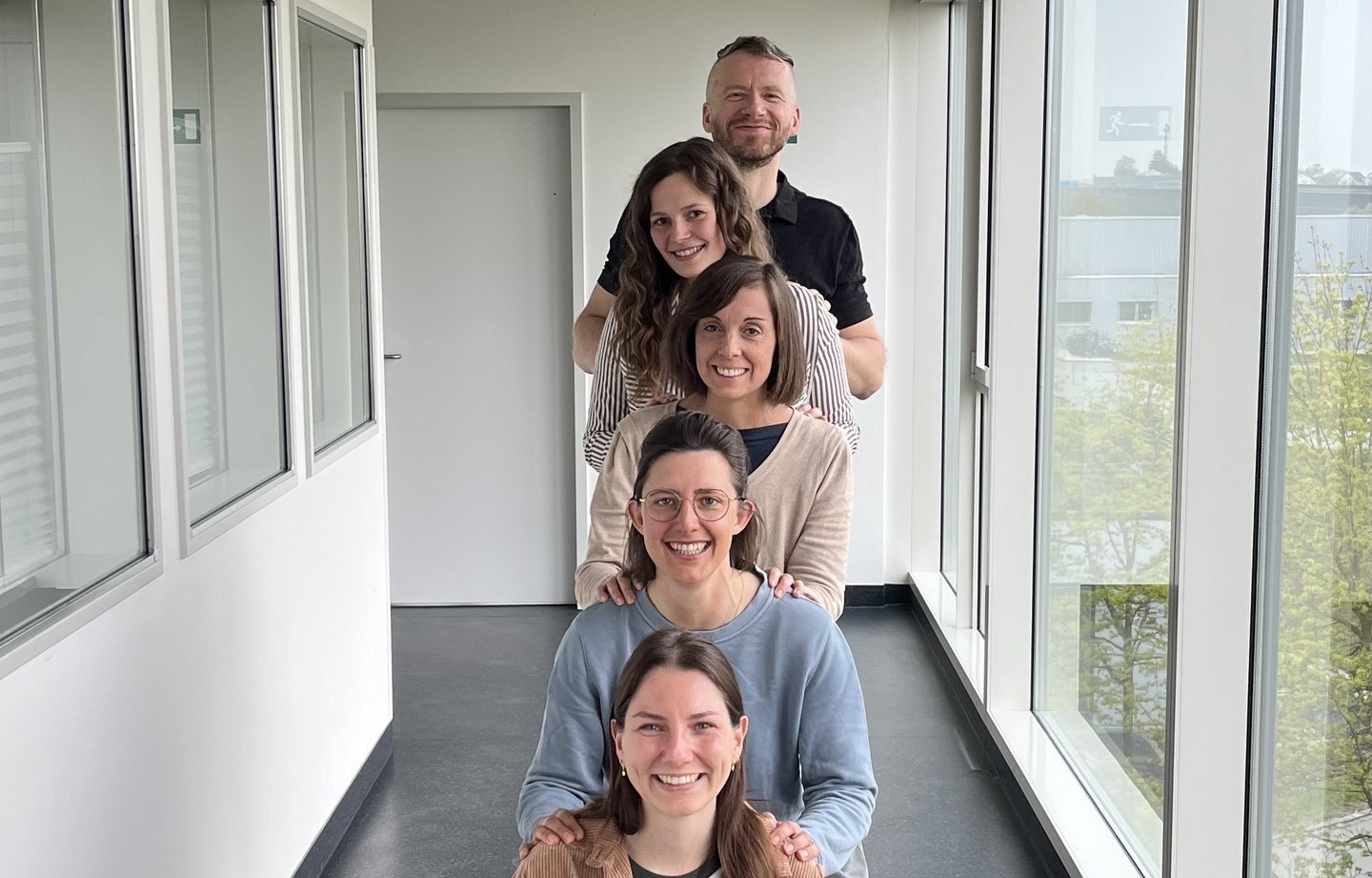 Gruppenbild der Projektverantwortlichen, die freundlich in die Kamera lächeln.