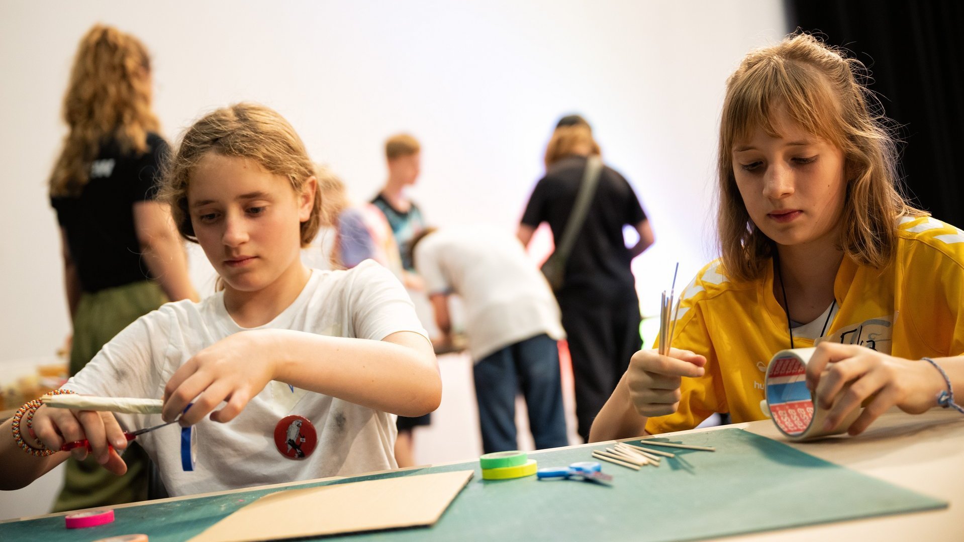 Zwei Schülerinnen basteln Windkraftmodelle.