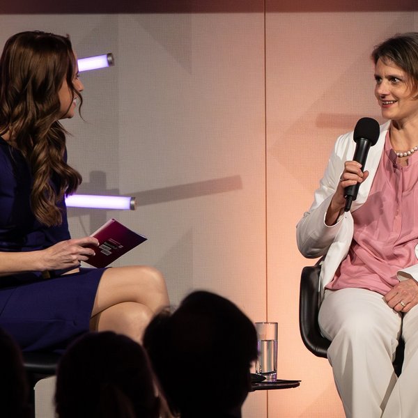 Dr. Anna Heimsath, Leiterin des Geschäftsfeldes Solarkraftwerke und Integrierte PV am Fraunhofer ISE, sitzt neben der Moderatorin Susanne Schöne und spricht in ein Mikrofon.